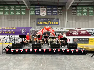 Band sitting on a stage in an arena