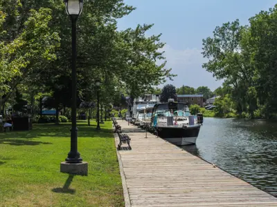 Boats docked at a boardwalk in the summer