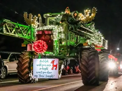 People on a tractor with Christmas lights for the Parade of Lights